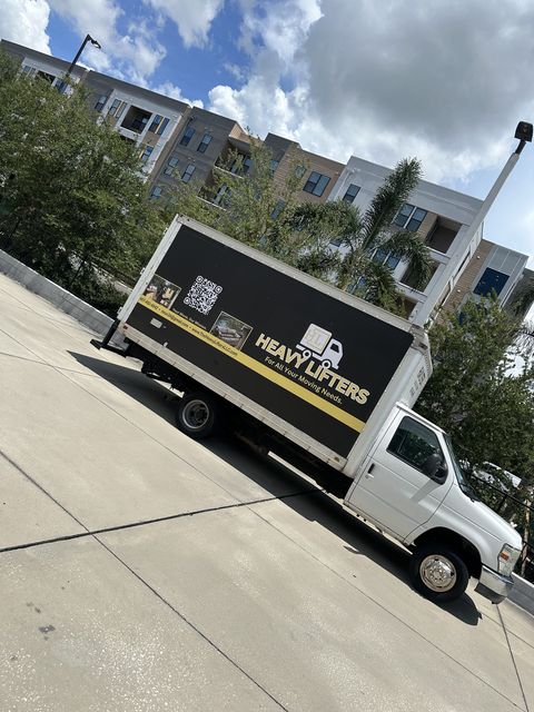 Heavy Lifters truck parked outside an apartment building
