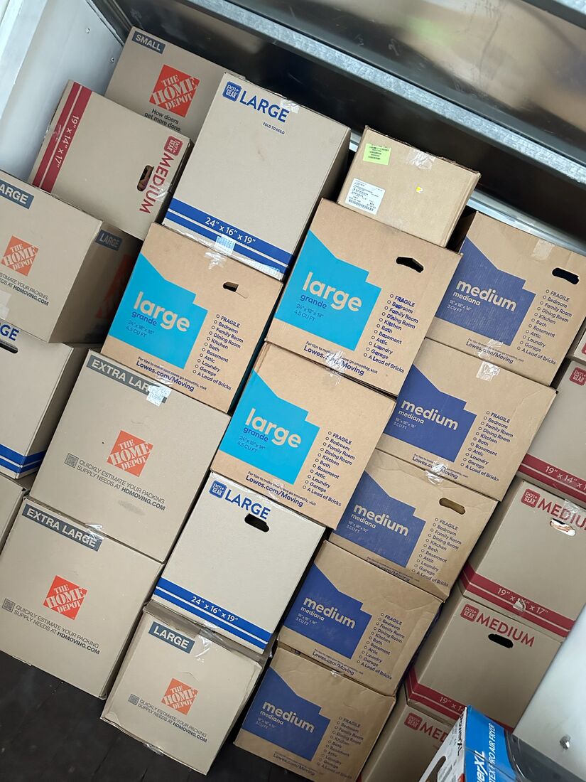 Neatly stacked and labeled moving boxes packed by Heavy Lifters — movers serving Gainesville, FL