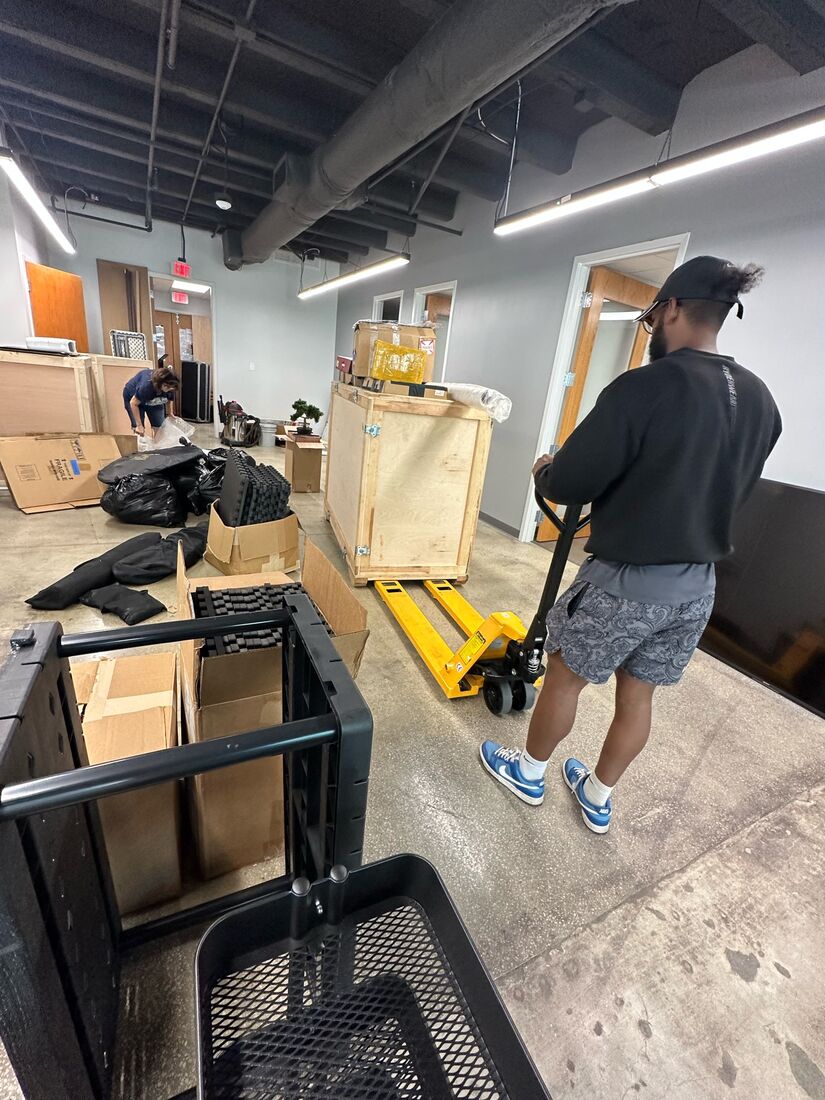 Heavy Lifters crew moving boxes with a dolly — movers serving Clearwater, FL