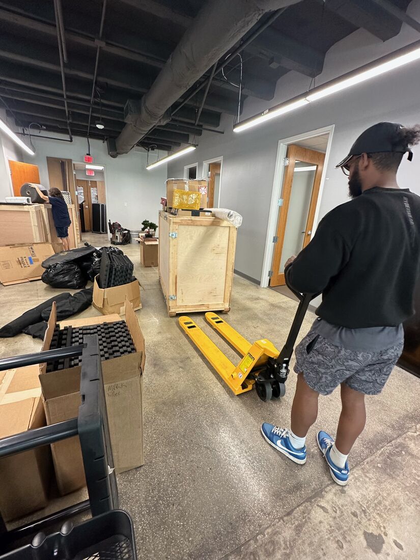 Heavy Lifters movers carrying items through a hallway — movers serving Palm Beach Gardens, FL